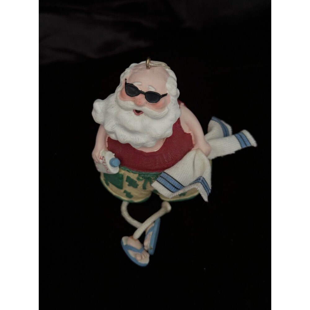 Tropical Beach Santa Claus, dangle legs, towel, sun lotion, Christmas Ornament